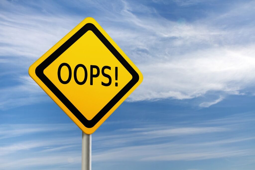 Yellow Road Sign reading "oops" - Travel Mistakes to Avoid