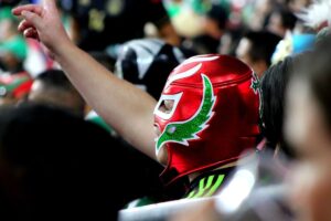 Mexican wearing a Lucha Libre Mask watching a Lucha Libre Flight