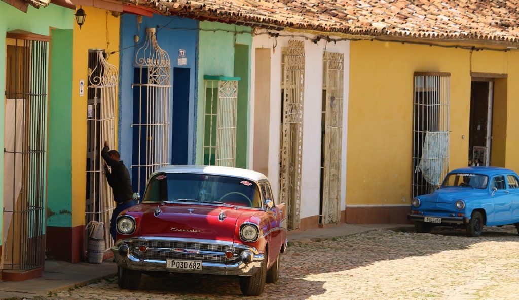 Classic cars outside colourful houses in Cuba