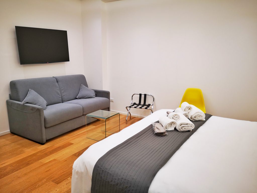 The TV & Sofa in My Bedroom at Kalamonjo Suite&Rooms - The Mandorla Room