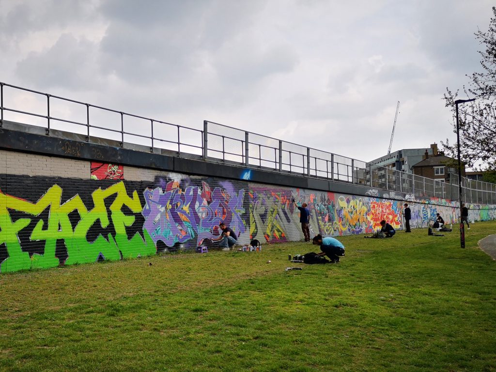 Street Artists at Work by the Trainlines close to Brick Lane