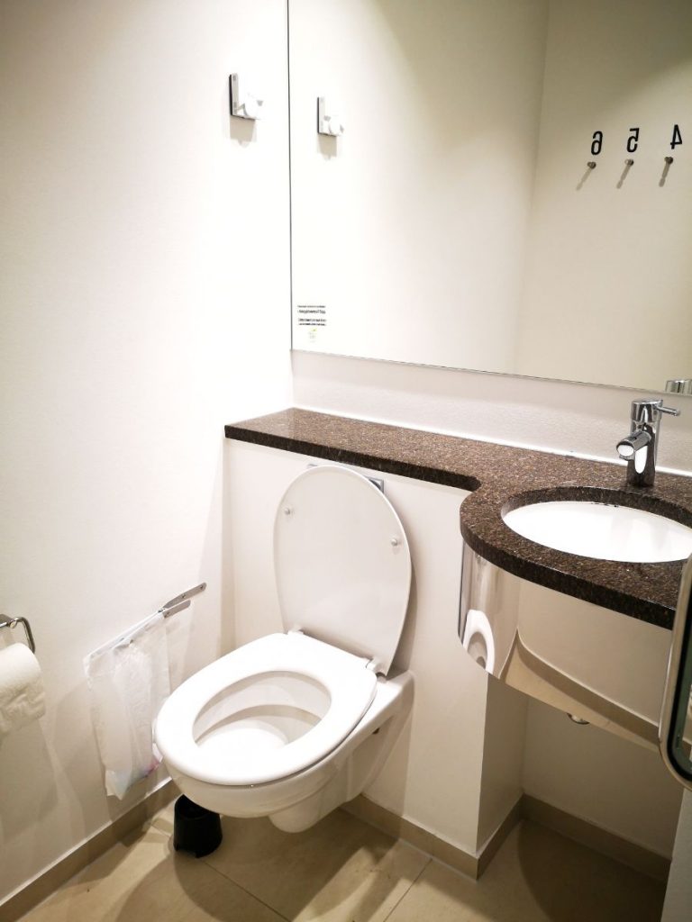 Bathroom with numbered hooks for towels