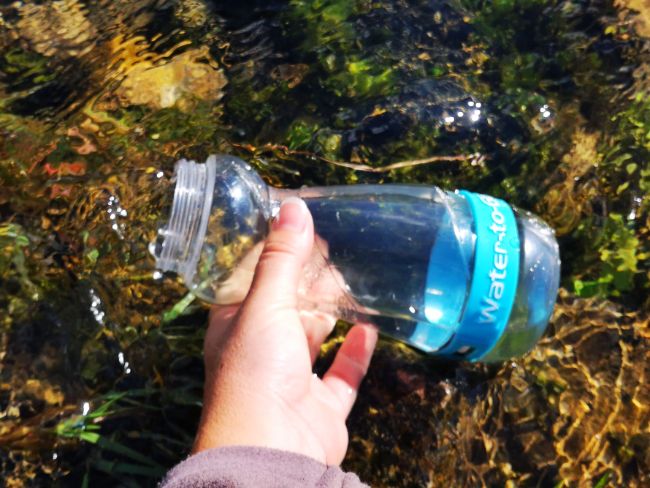 Filling up in the River - The Best Filtered Water Bottle for Travel