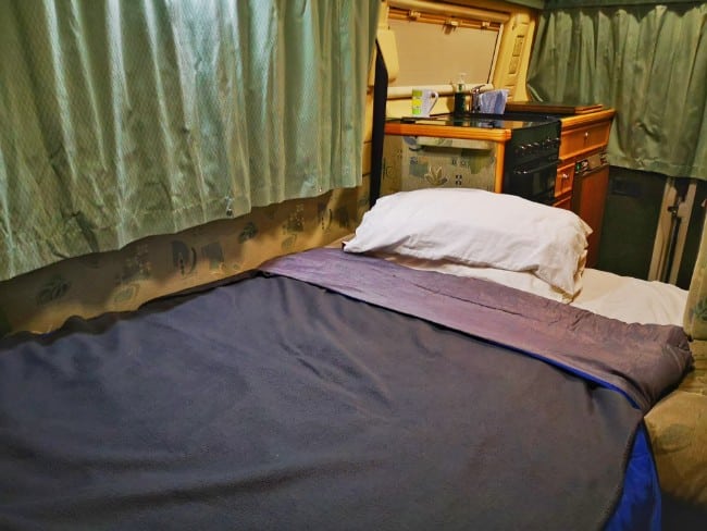 My bed in the campervan, with a pillow and blankets and duvet - Settling Down for the Night in Mable the Motorhome