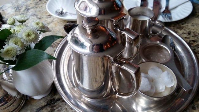 A Pot of Tea is the Usual Drink for Afternoon Tea - Silver teapot on a tray with sugar cubes