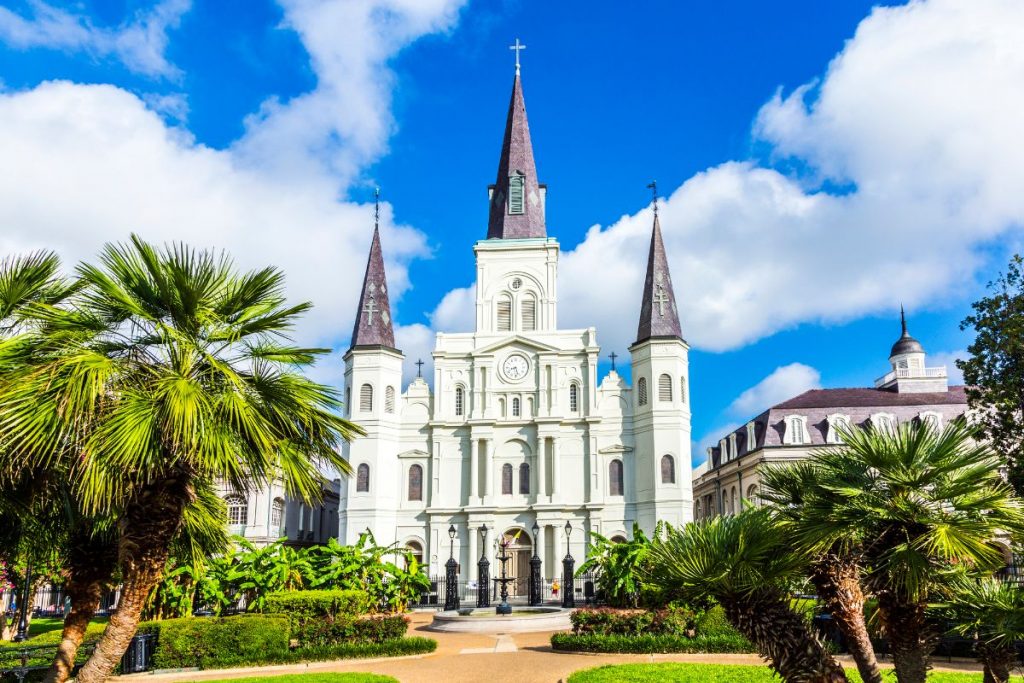 Free Things to do in New Orleans - Jackson Square and the white castle-like St Louis Cathedral with blue skies behind
