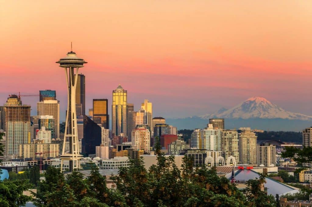 Free Things to do in Seattle Washington - the Seattle Skyline at Sunset with the Space Needle and Mount Rainier visible.