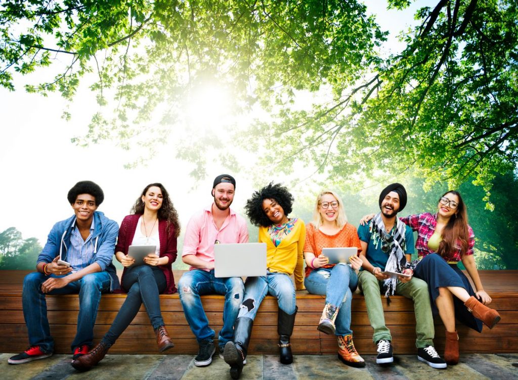 Workaway Alternatives for Work Exchanges - Group of people sitting down and laughing together
