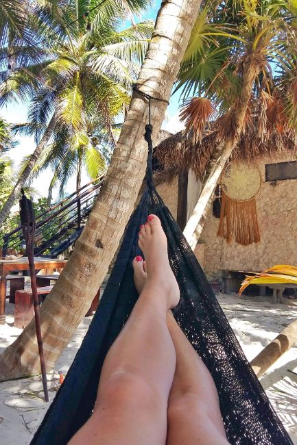 Photo of my Legs in a Hammock surrounded by palm trees - Chilling Out in a Hammock on the Beach