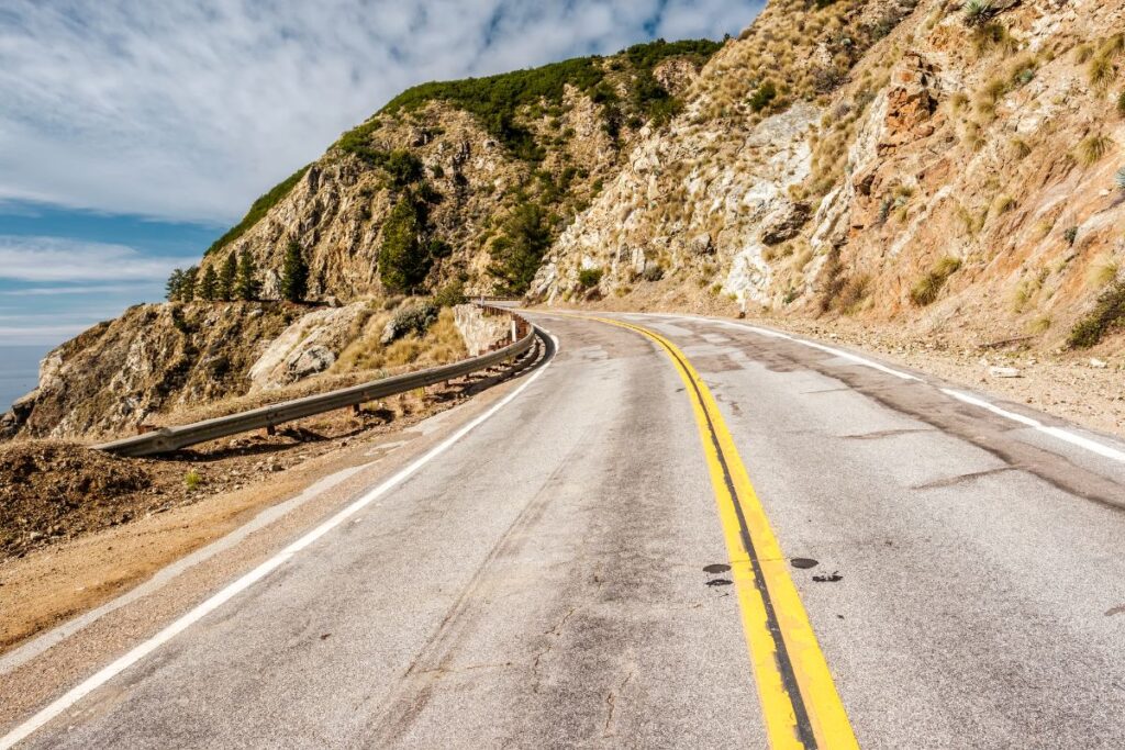 Part of the Pacific Coast Highway Road running next to the sea - The Best West Coast Road Trips in the USA