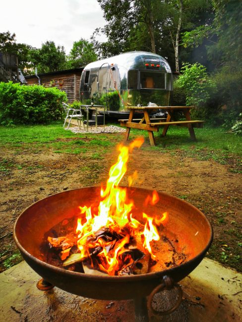 Fire Pit Campfire in the foregroun with the vintage Airstream Glamping Trailer behind - We Finally got the Campfire Going! The Best Bit of Camping