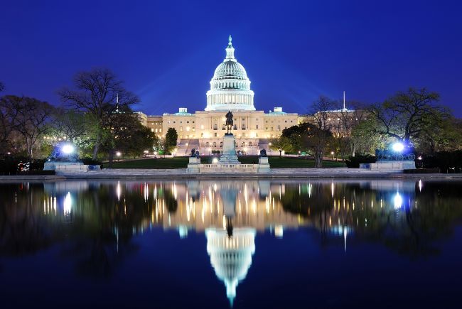 The Capitol Building lit up at night with the reflection in water in front of it- Free Things to do in Washington DC