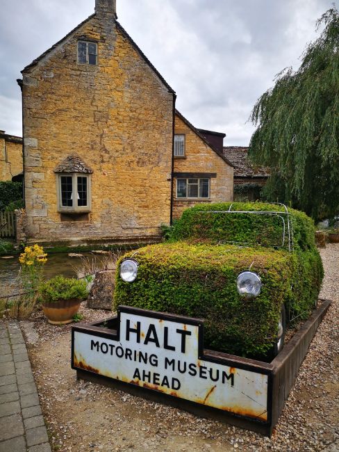 Model of a Mini covered in grass at The Entrance to the Motoring Museum