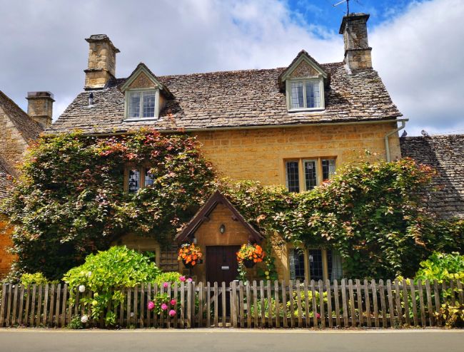 Typical yellow limestone cottage in the Cotswolds