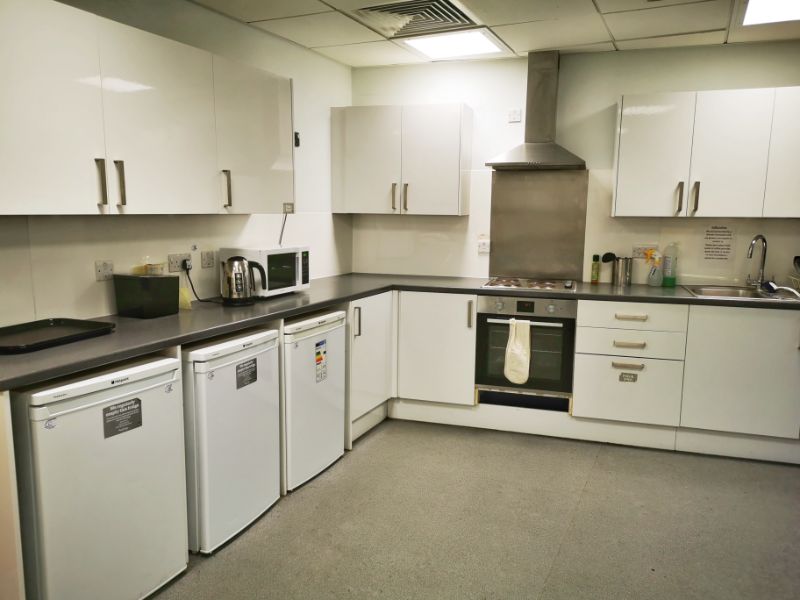 Shared Cooking and Kitchen Facilities at YHA the Sill - large kitchen with which cabinets and dark work surface