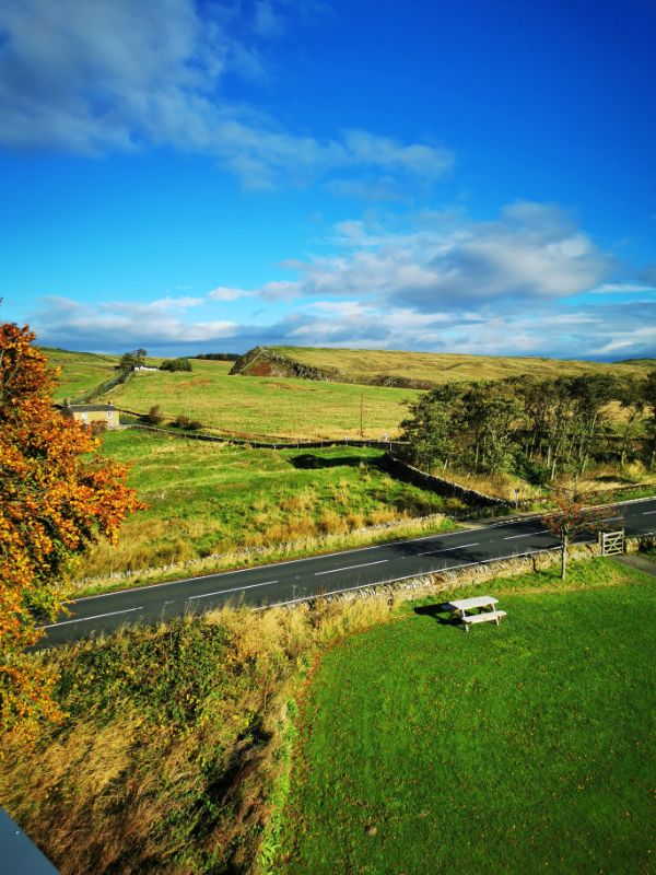 The View from the Rooftop of The Sill National Discovery Centre towards green fields with Hadrian's Wall just visible along the top of the horizon