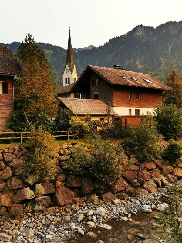 Church and rustic building in The pretty village of Mellau in Vorarlberg Austria