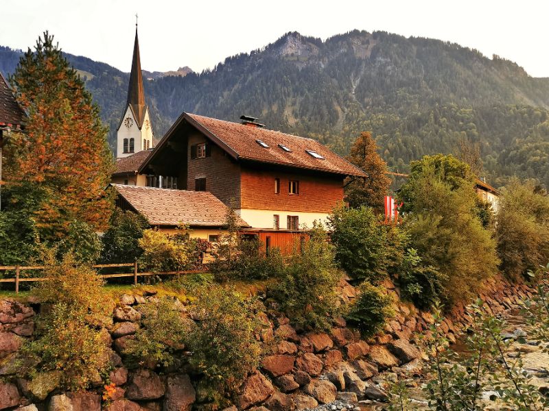 Church and rustic building in The pretty village of Mellau in Vorarlberg Austria