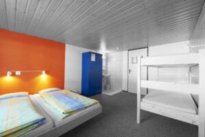 Hostel Room with bunk beds and two single beds - Working as a Hostel Volunteer