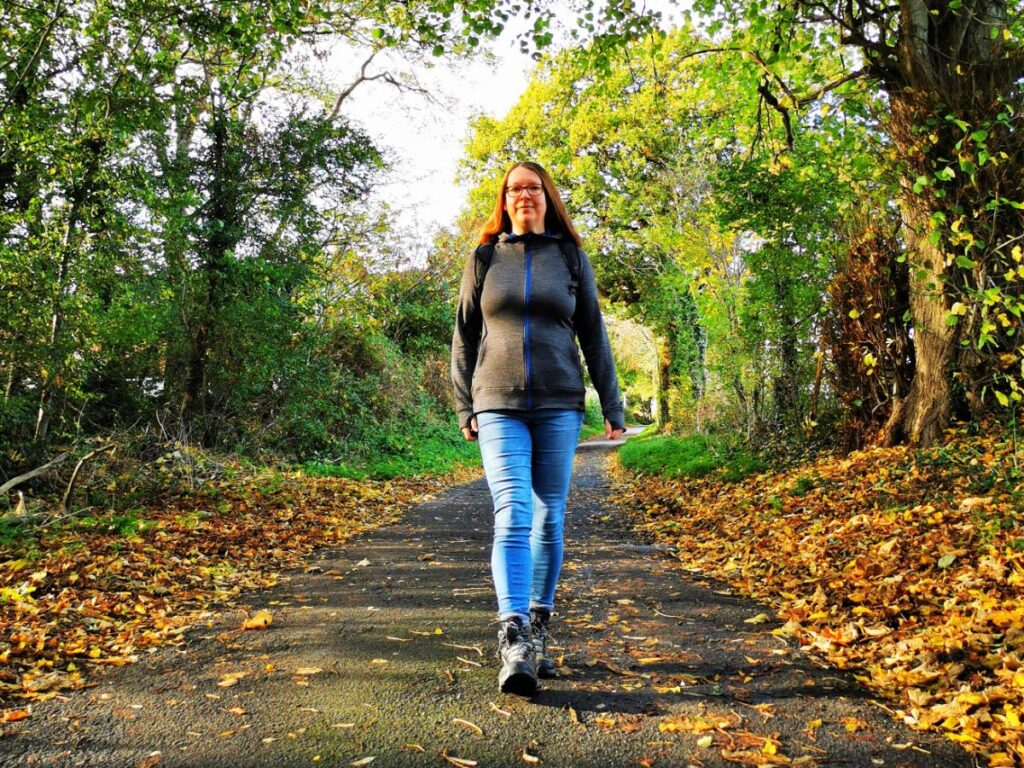 Me walking in the Woods wearing a dark grey my Merino Wool Hoodie - Isobaa Review