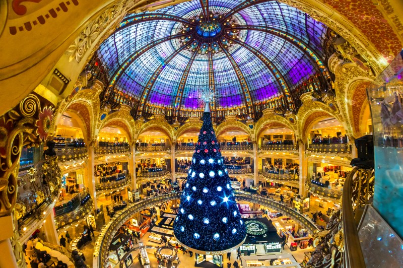 Christmas Decorations in Galleries Lafayette - a large Christmas tree in the centre of a shopping arcade with a beautiful glass dome roof