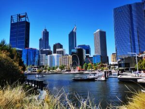 Elizabeth Quay in Perth - Grass in the foreground with the water and tall buildings of Perth in the background -