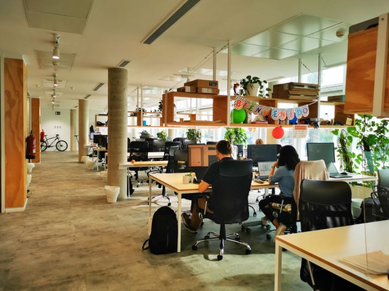 A Co-Working Space in Barcelona with desks and people working - Digital Nomad Essentials