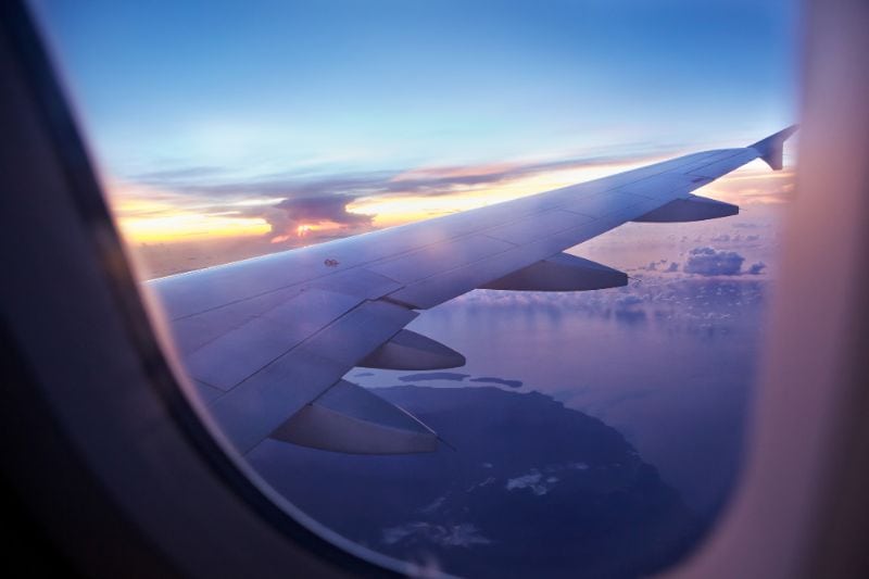 View of a plane wing out of the window of an aeroplane