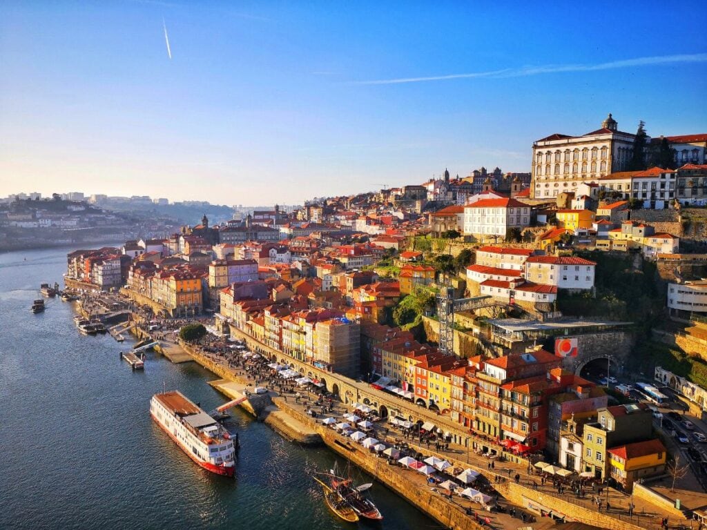View of Porto Porto from the Luis I Bridge with the River Douro and colurful buildings leading up on the hilly bank