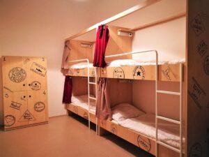 A Hostel Dorm Room with 4 sturdy beds with privacy curtains and lockers - Comfortable Backpacker Accommodation