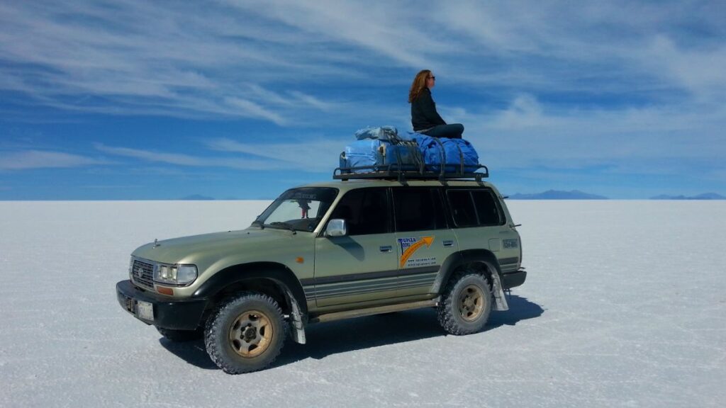 Sitting Alone on top of a Land Cruiser in the Salt Flats of Bolivia - the Disadvantages of Solo Travel