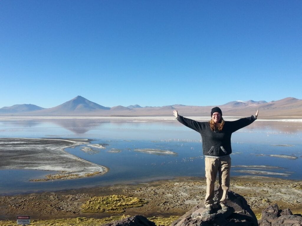 Me on a Solo Trip in Bolivia with a beautiful blue lake behind me - The Benefits of Solo Travel