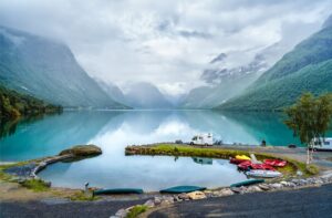 A Motorhome next to a Fjord in Norway with Mountains in the Background - How to Plan a Norway Motorhome Adventure