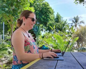 Claire Working on a Picnic Bench Outdoors - SafetyWing Insurance Review