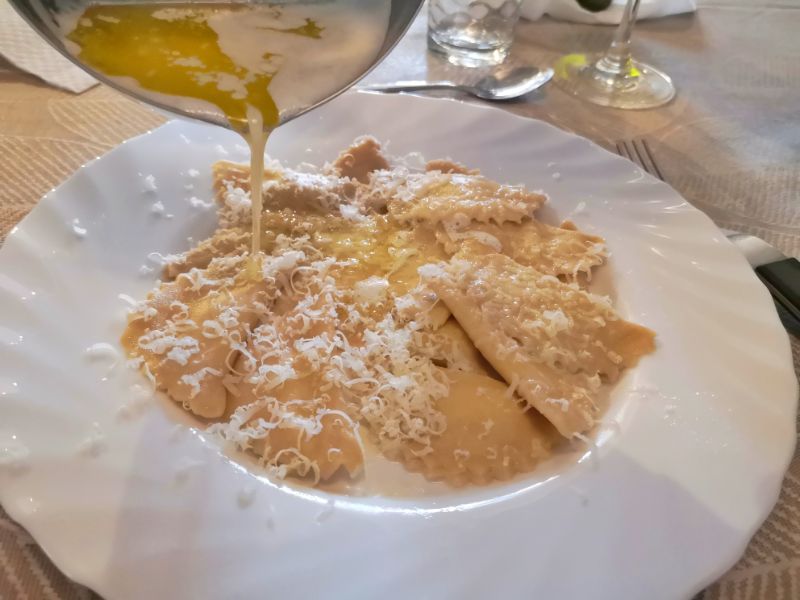 Serving the ravioli with melted butter and grated cheese